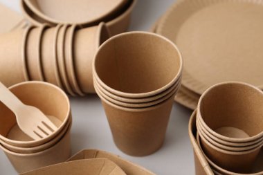 Set of disposable tableware on white background, closeup