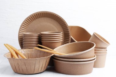 Set of disposable tableware on white table, closeup