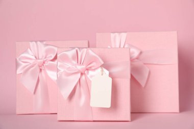 Pembe arka planda boş etiketli hediye kutuları
