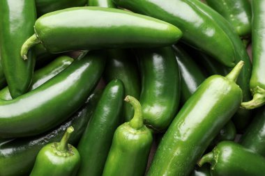 Fresh green jalapeno peppers on table, closeup