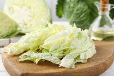 Fresh cut Savoy cabbage on white table, closeup