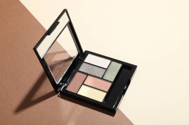 Beautiful eyeshadow palette on color background. Space for text