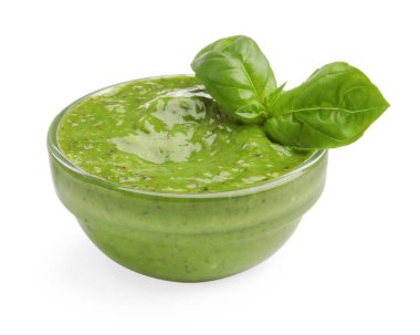 Pesto sauce with basil leaves in bowl isolated on white