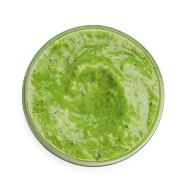 Fresh pesto sauce in bowl isolated on white, top view