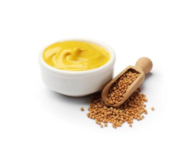 Tasty mustard sauce and dry seeds isolated on white