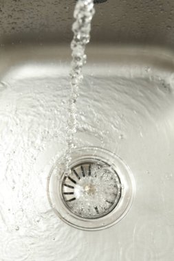 Water going down sink drain, above view