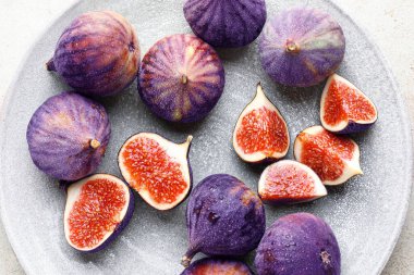 Whole and cut figs on table, flat lay