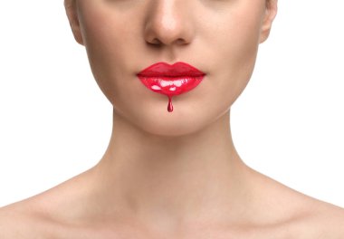 Kadının dudağından beyaz arka plana damlayan kırmızı sıvı ruj, yakın plan.