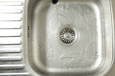Water going down sink drain, top view