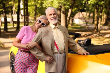 Modern Cabriolet yakınlarında şık bir yaşlı çift.