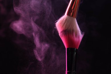 Siyah arka planda pembe göz farlı makyaj fırçaları, yakın plan. Metin için boşluk