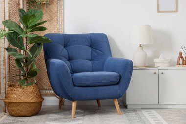 Comfortable blue armchair in living room. Interior design