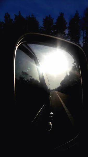 car mirror reflection of the morning sun in the mirror the terra