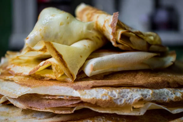 Appetizing golden pancakes with crispy crust, cooked at home. Fatty and hot pancakes on milk