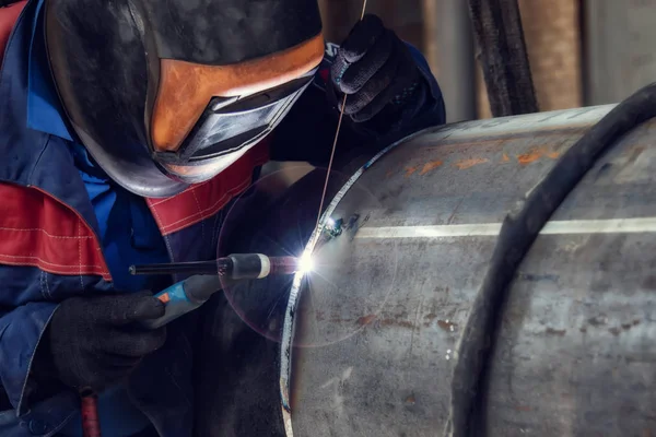 stock image Assembly of pipeline assemblies in the Assembly shop using argon-arc welding. Welder, arc welding and weld seam close-up