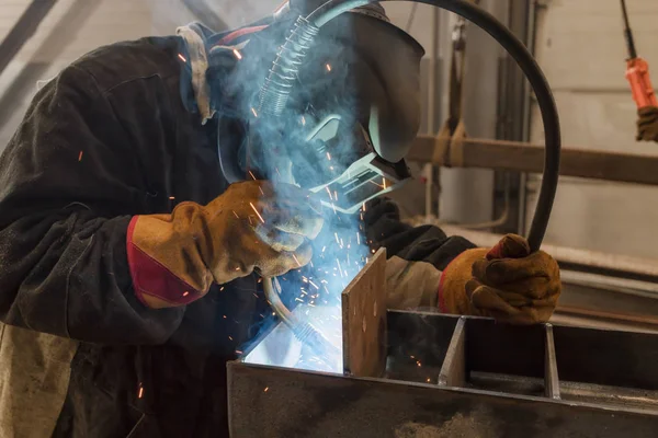 Schweißer führt Schweißarbeiten an Metallkonstruktionen aus — Stockfoto