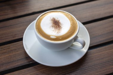 Cappuccino kahve ahşap tepsi, siyah arka plan kabarcıkları ile.
