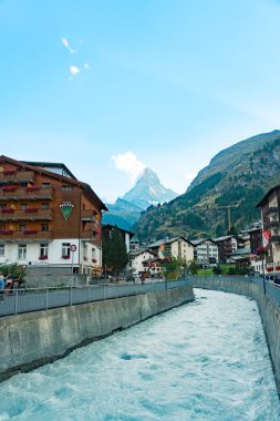 City of Zermatt with the Matterhorn in the background, tourists lodges, hotels and the Matter Vispa river flowing through the center