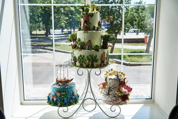 Beautiful unusual festive cakes with decor on a stand.