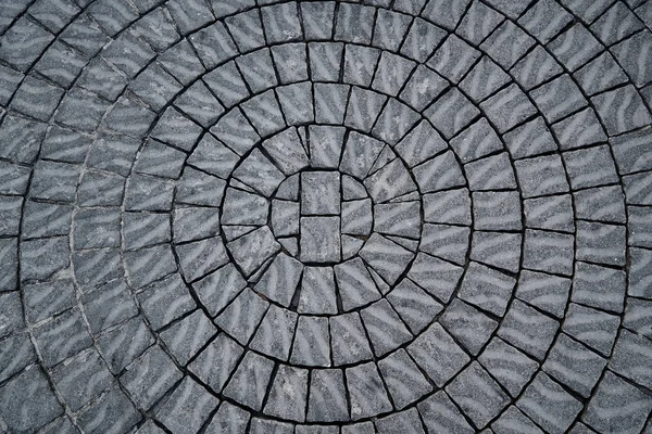 Background, texture of the paving stone laid out in a circle.