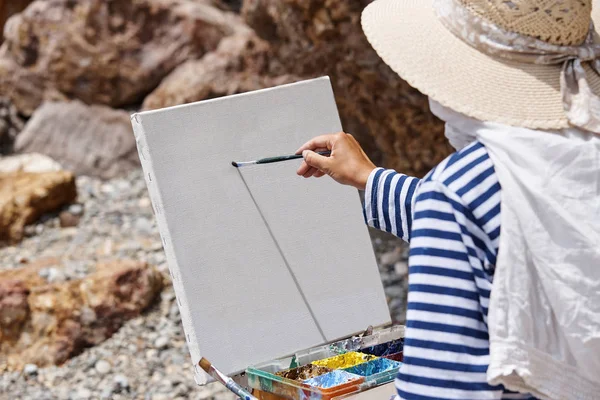 The artist with an easel and colorful paints.