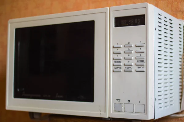 old-fashioned old microwave oven which is not produced in the kitchen