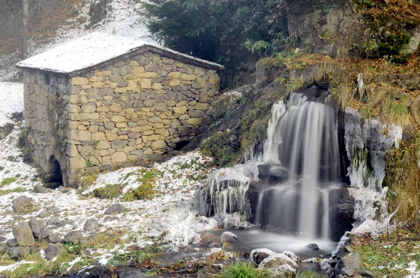 Water mill near a stream in winter.Long exposured frozen water.Caykara,Trabzon Turkey