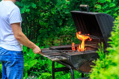 Beyaz t-shirt erkekler Barbekü yer yangın hazırlanıyor