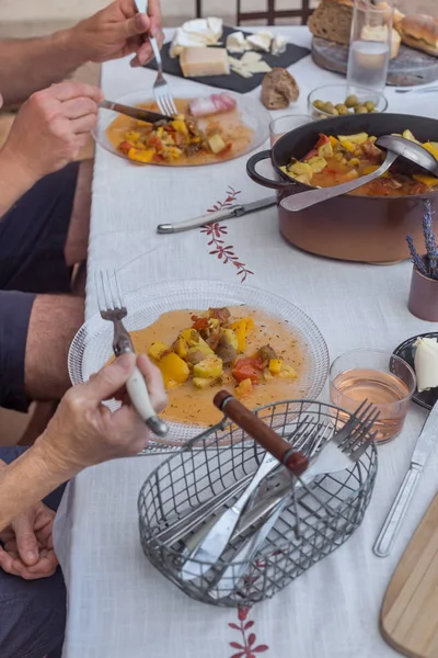 hands of elders couple having dinner together homemade food process of eating white tablecloth