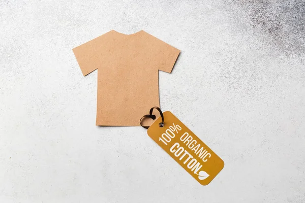 Organic cotton clothing concept with label. Paper craft t-shirt. Eco-clothing