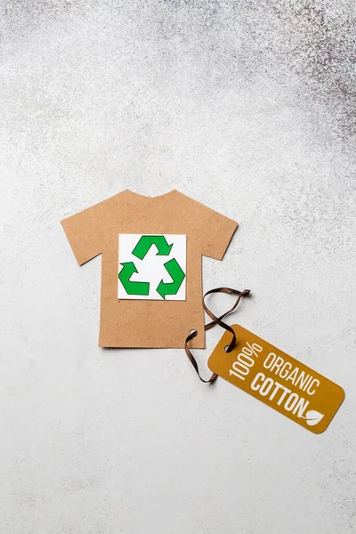 Organic cotton clothing concept with label. Paper craft t-shirt. Eco-clothing