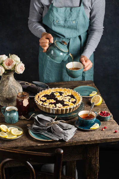 Tea party at the autumn tablewith whith berry pie and a cup of hot tea.