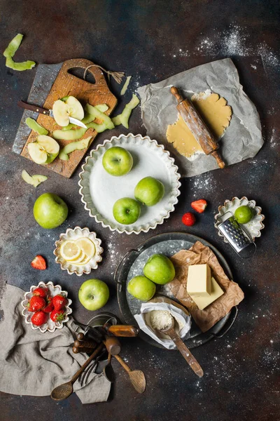 Variety of food products on the kitchen table. Pie making process, top view.