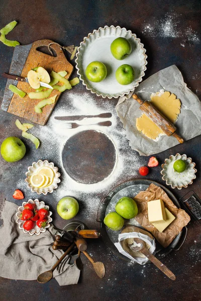 Variety of food products on the kitchen table. Pie making process, top view. Space for text — Stock Photo, Image
