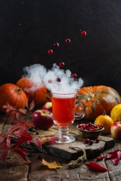 Autumn still life. Creative concept. Berries levitate over a cup of hot drink — Stock Photo, Image