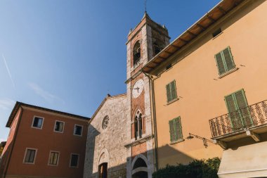 low angle view of buildings and clear blue sky in Tuscany, Italy clipart
