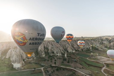 CAPPADOCIA, TURKEY - 09 MAY, 2018: beautiful hot air balloons flying above scenic landscape in cappadocia, turkey      clipart