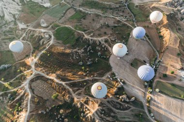 CAPPADOCIA, TURKEY - 09 MAY, 2018: top view of hot air balloons flying above famous goreme national park, cappadocia, turkey   clipart