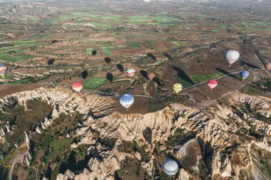CAPPADOCIA, TURKEY - 09 MAY, 2018: aerial view of various colorful hot air balloons flying above cappadocia, turkey clipart