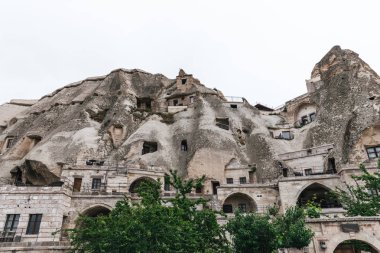 low angle view of beautiful rock formations and buildings in cappadocia, turkey clipart