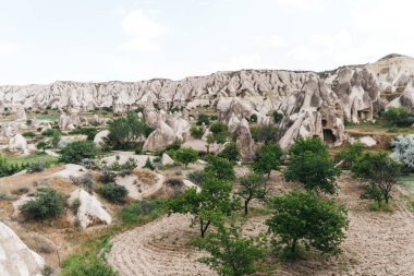 beautiful view of famous rock formations and caves in cappadocia, turkey   clipart