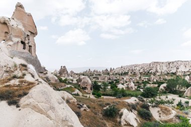 majestic view of famous rock formations and caves in cappadocia, turkey   clipart