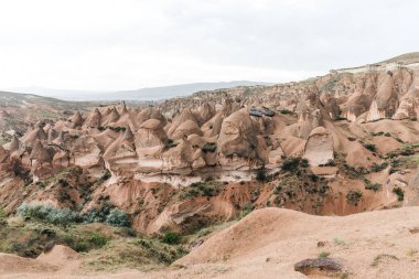 beautiful landscape with majestic rock formations in cappadocia, turkey clipart