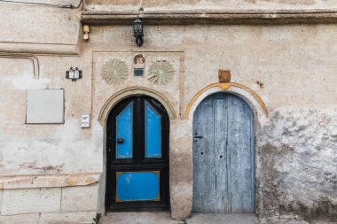 two wooden doors in traditional old building, cappadocia, turkey clipart