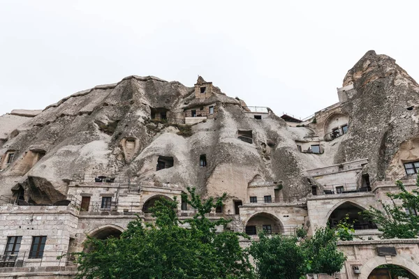 low angle view of beautiful rock formations and buildings in cappadocia, turkey