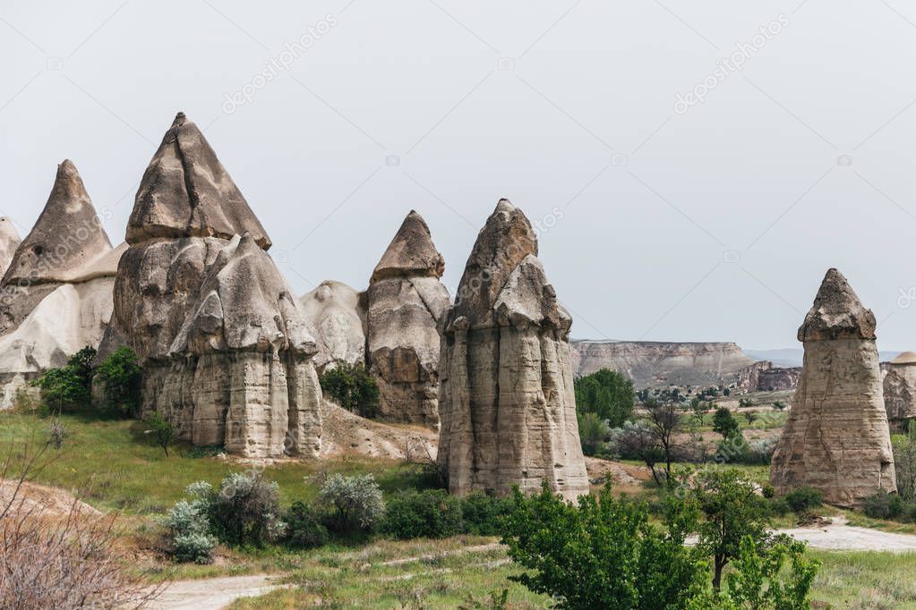 beautiful rock formations against cloudy sky in famous cappadocia, turkey 