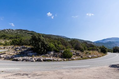 empty winding road in scenic mountains, provence, france  clipart