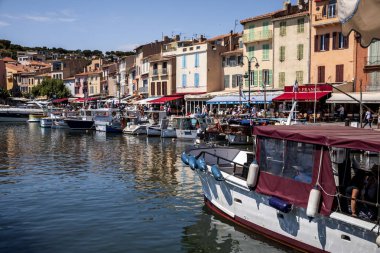 AVIGNON, FRANCE - JUNE 18, 2018: boats in port and people walking on embankment, Avignon, france  clipart