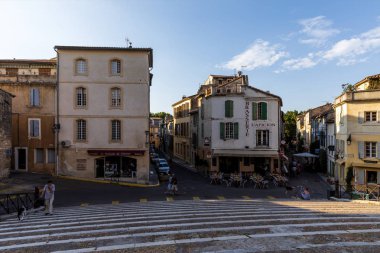 PROVENCE, FRANCE - JUNE 18, 2018: pedestrians and cars on streets and square with beautiful old architecture clipart