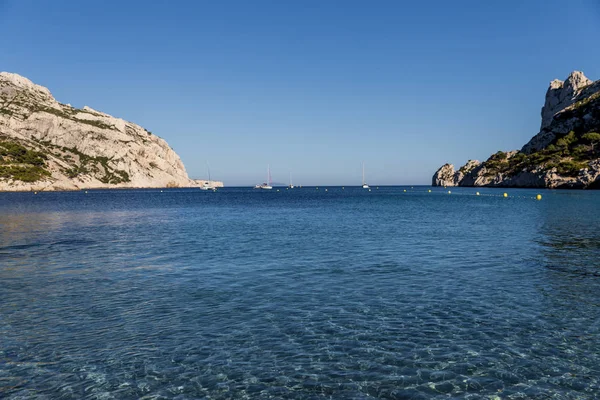 yachts and boats in calm sea harbour and scenic cliffs, Calanques de Marseille (Massif des Calanques), provence, france